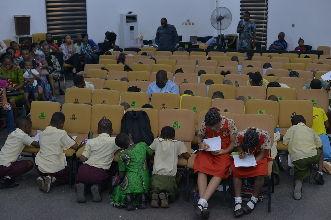 A wide view of the event hall and seated participants.