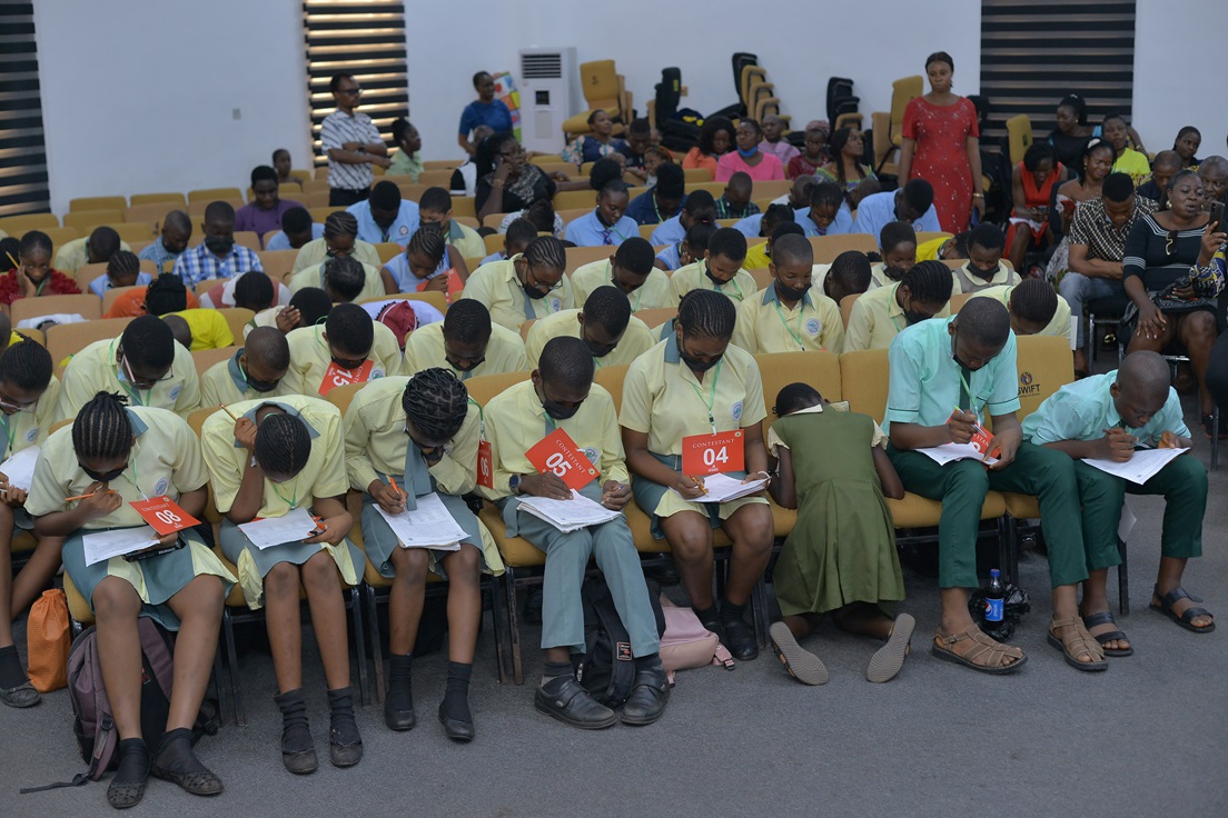 A wide view of participants working on their papers.