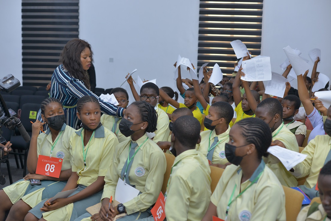 A facilitator speaking with seated participants.