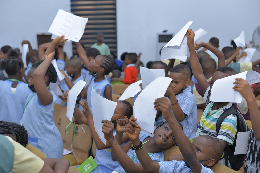 Participants raising papers during an interactive session.